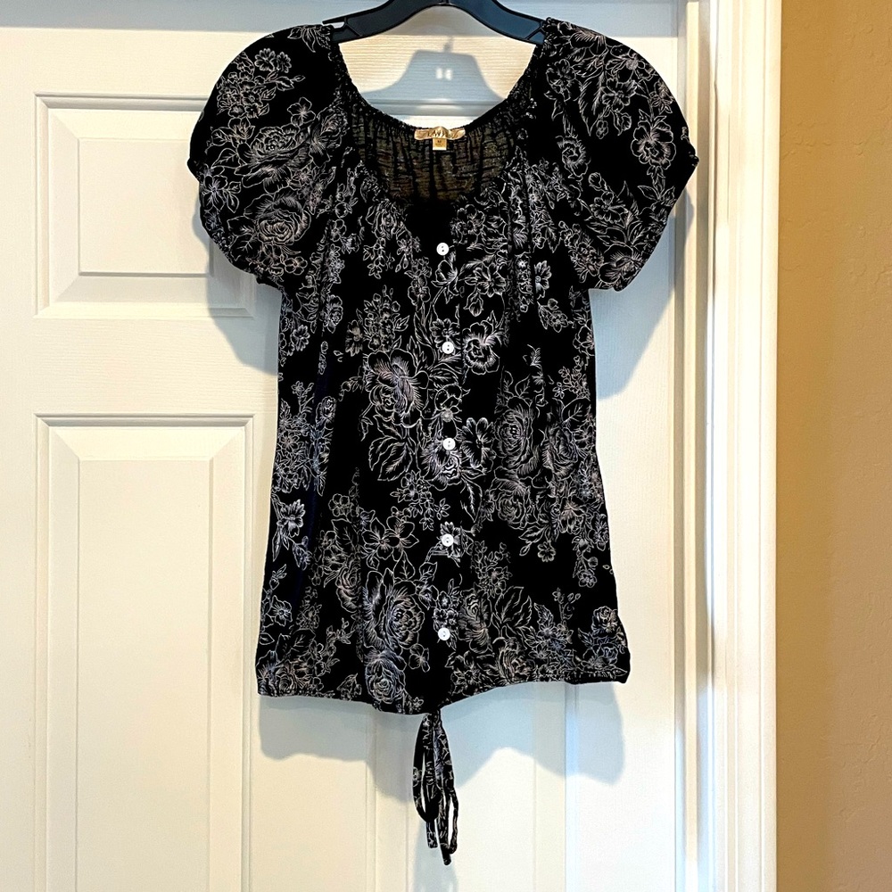 Women’s short sleeved black top with white flowers